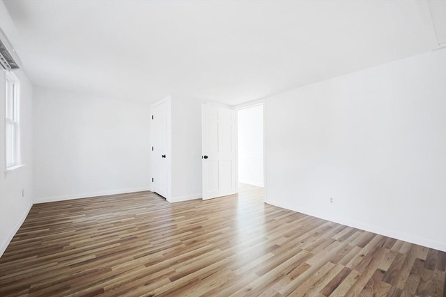 spare room featuring light hardwood / wood-style floors