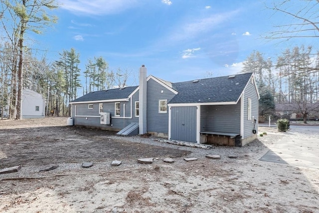 rear view of house featuring ac unit