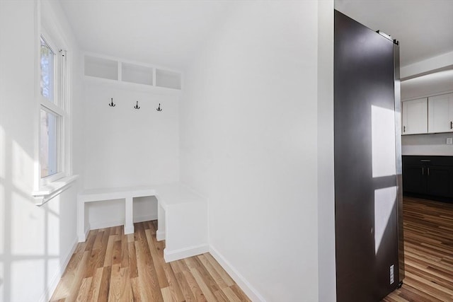 mudroom with light hardwood / wood-style floors