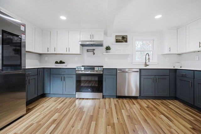 kitchen featuring sink, gray cabinets, light hardwood / wood-style floors, white cabinetry, and stainless steel appliances