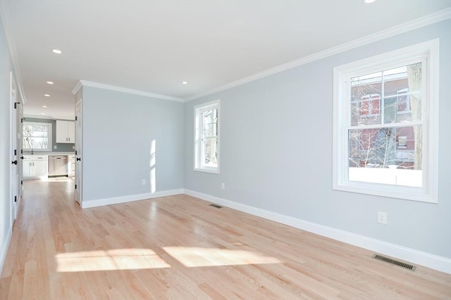 spare room with crown molding and light hardwood / wood-style floors