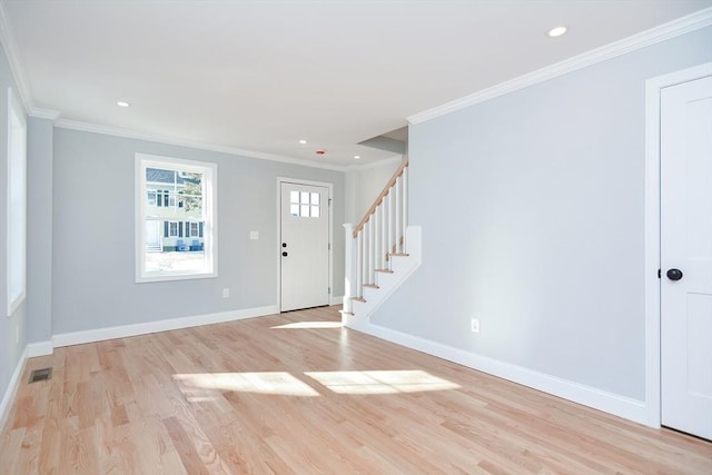 entrance foyer featuring crown molding and light wood-type flooring