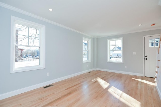 interior space with crown molding and light hardwood / wood-style floors