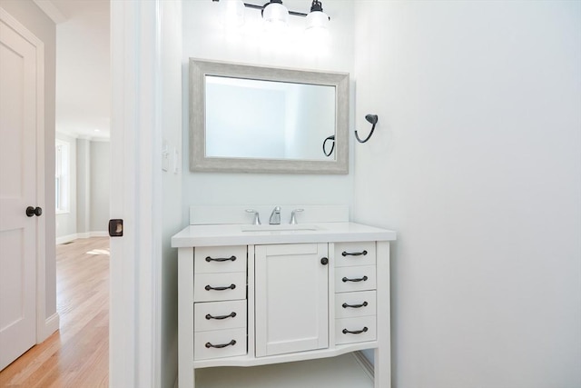 bathroom with vanity and wood-type flooring