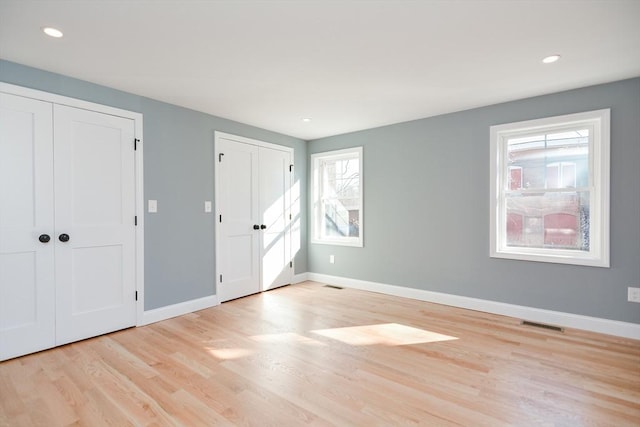 unfurnished bedroom featuring light wood-type flooring