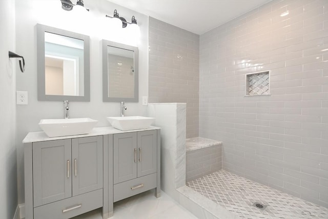 bathroom featuring vanity and tiled shower