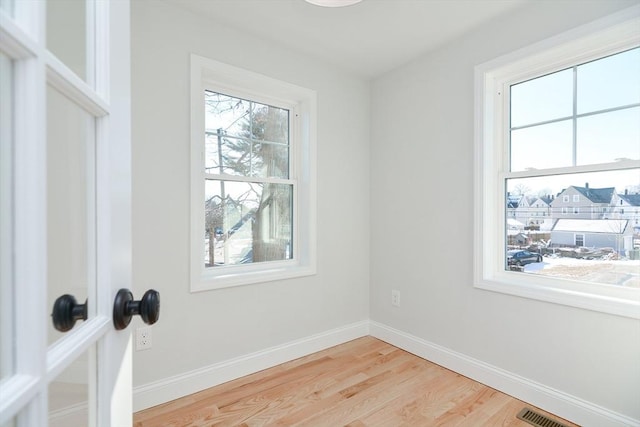 empty room with hardwood / wood-style floors