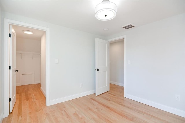 unfurnished room with light wood-type flooring