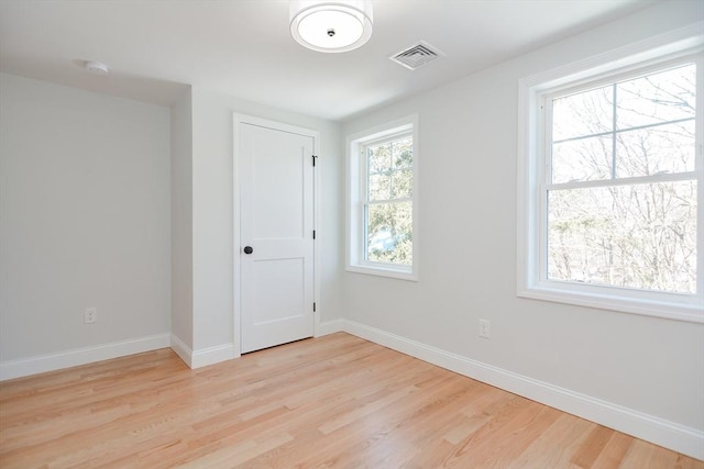 spare room featuring light wood-type flooring