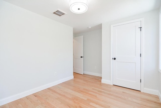 empty room with light hardwood / wood-style floors