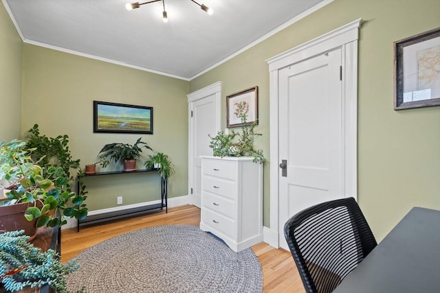 office area featuring baseboards, ornamental molding, and light wood-type flooring