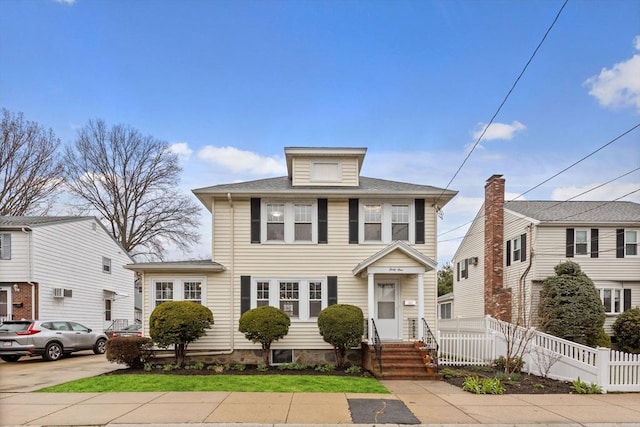 american foursquare style home with fence
