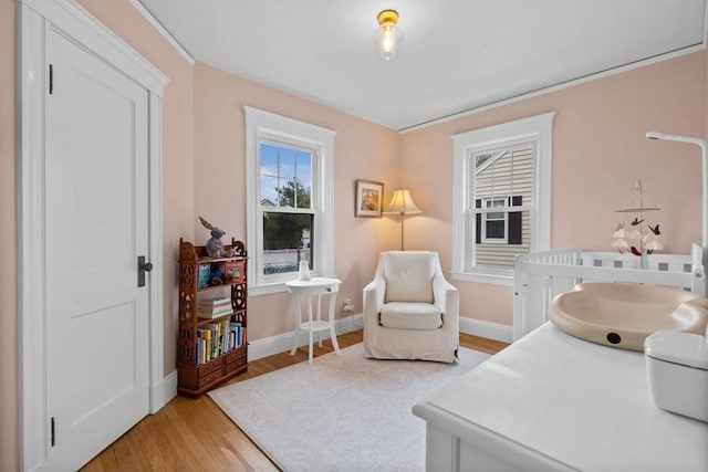 interior space featuring baseboards and light wood finished floors
