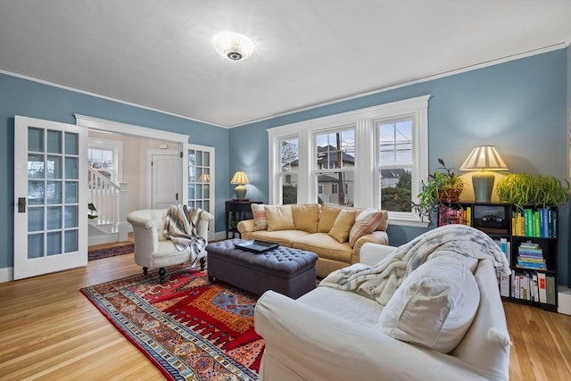 living room featuring ornamental molding, french doors, and wood finished floors