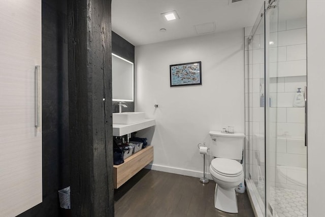 bathroom with vanity, hardwood / wood-style floors, an enclosed shower, and toilet