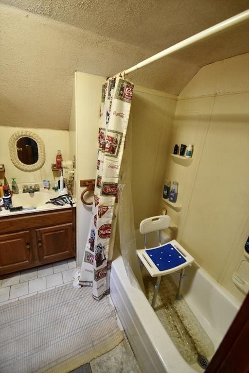 bathroom featuring vaulted ceiling, shower / bath combo, and vanity