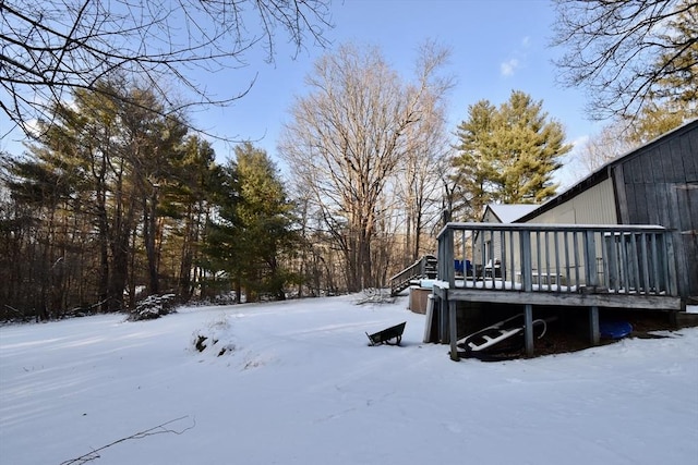 yard covered in snow featuring a deck