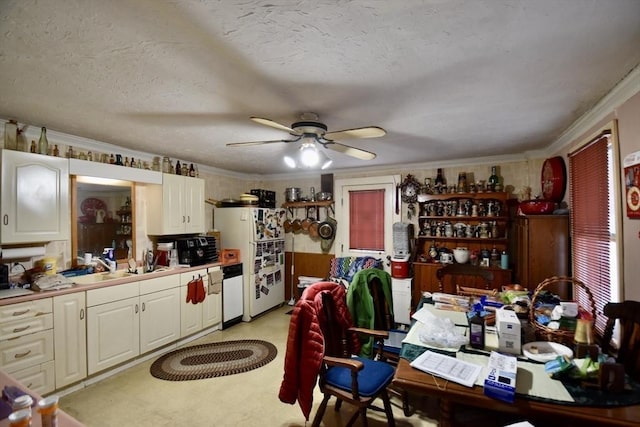 kitchen with crown molding, white appliances, sink, and a textured ceiling