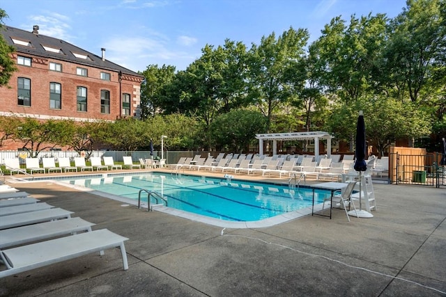 pool featuring a pergola, fence, and a patio area