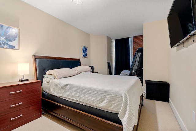 bedroom featuring baseboards and light carpet