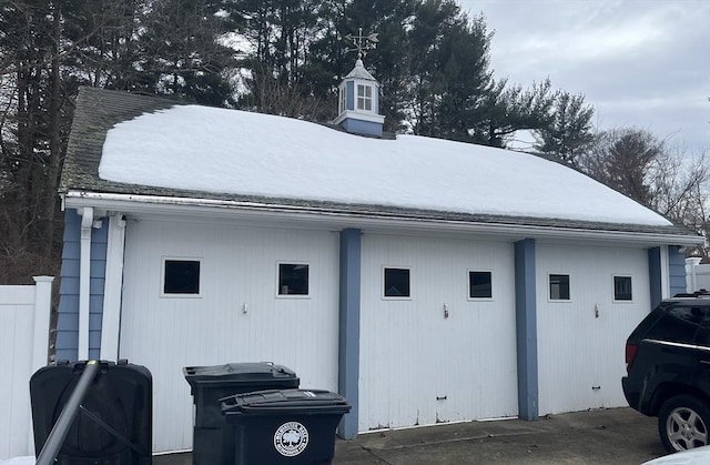 view of snow covered exterior with an outdoor structure