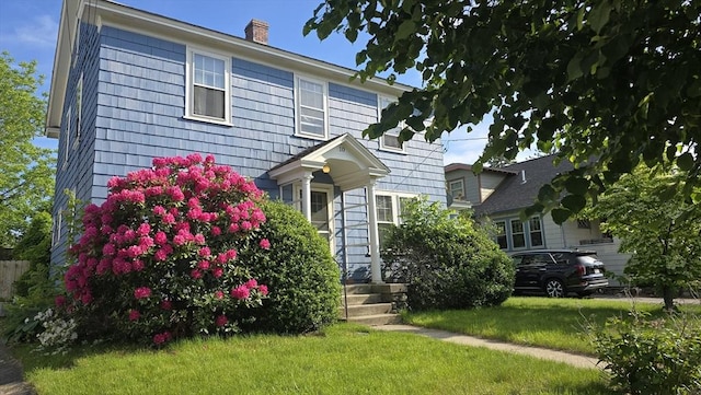 10 Arbutus Rd, Worcester, MA 01606 - view of front of home featuring a chimney and a front lawn