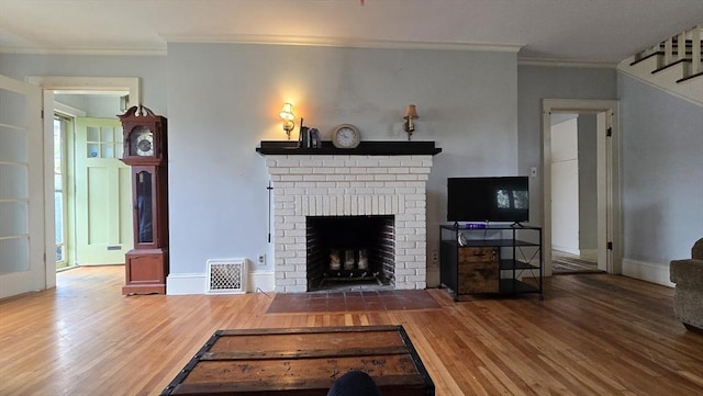 10 Arbutus Rd, Worcester, MA 01606 - living area featuring crown molding, wood finished floors, stairs, a brick fireplace, and baseboards