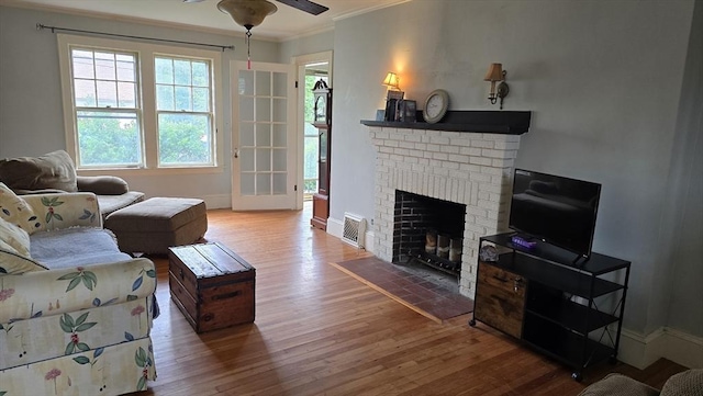 10 Arbutus Rd, Worcester, MA 01606 - living room with wood finished floors, ornamental molding, a brick fireplace, a ceiling fan, and baseboards