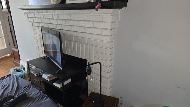 10 Arbutus Rd, Worcester, MA 01606 - detailed view of a brick fireplace and wood finished floors