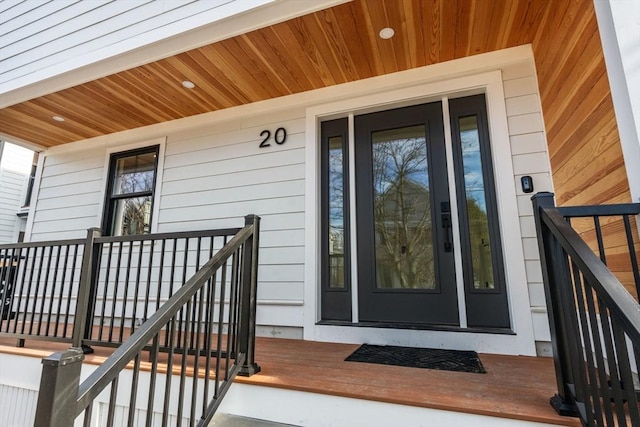 view of exterior entry featuring covered porch