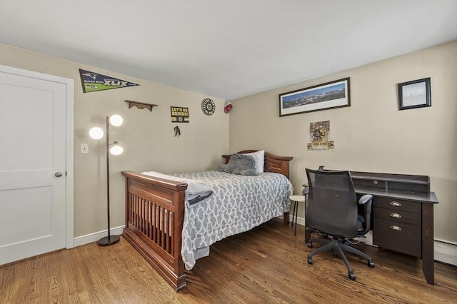 bedroom with baseboards and wood finished floors