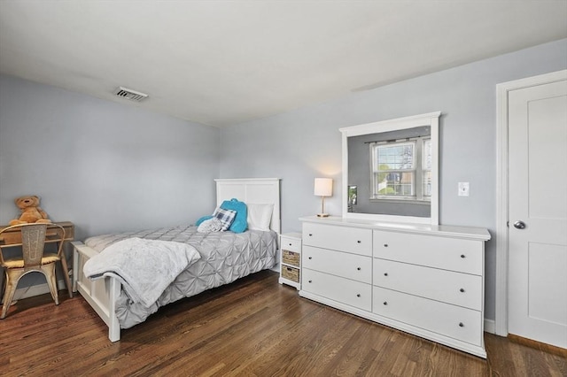 bedroom with visible vents and dark wood-type flooring