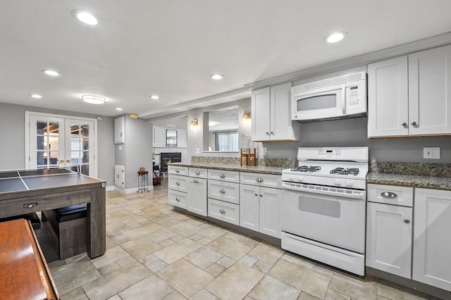 kitchen featuring white appliances, recessed lighting, baseboards, and french doors
