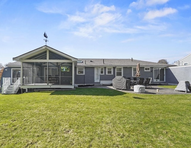 rear view of property featuring a sunroom, a lawn, and a patio