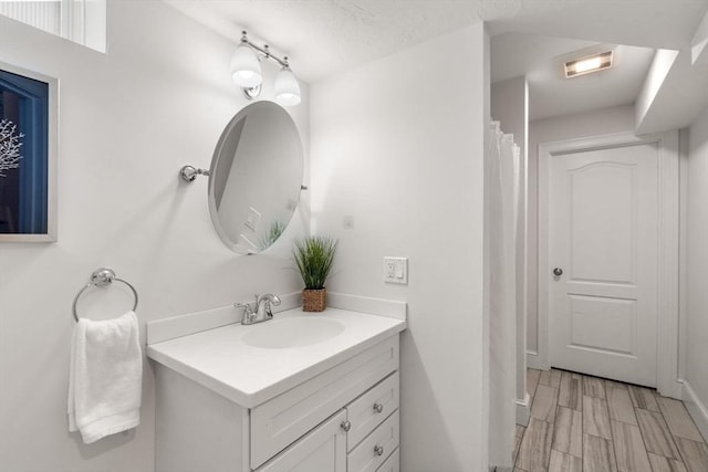 bathroom with vanity and hardwood / wood-style flooring