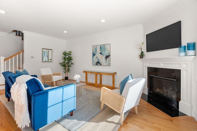 living room featuring ornamental molding and light hardwood / wood-style floors