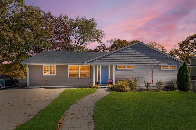 single story home featuring a yard