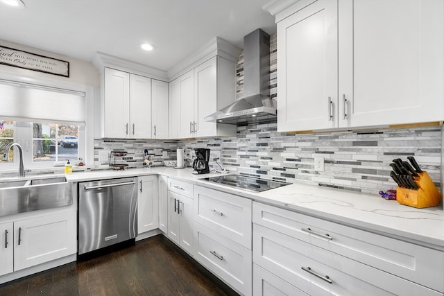 kitchen featuring black electric stovetop, wall chimney range hood, stainless steel dishwasher, white cabinetry, and dark hardwood / wood-style flooring