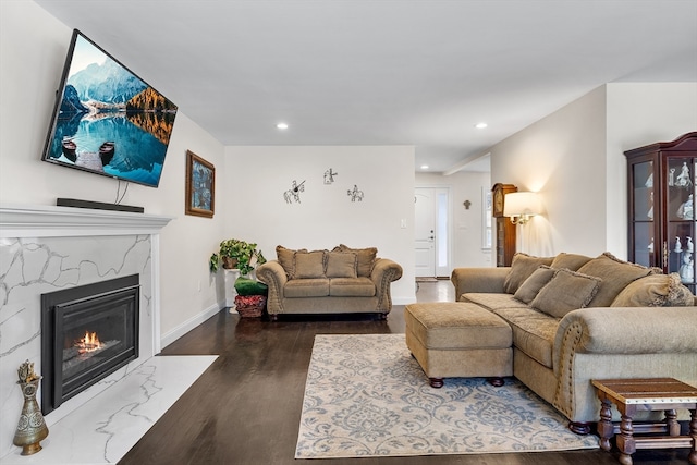 living room with dark wood-type flooring and a fireplace