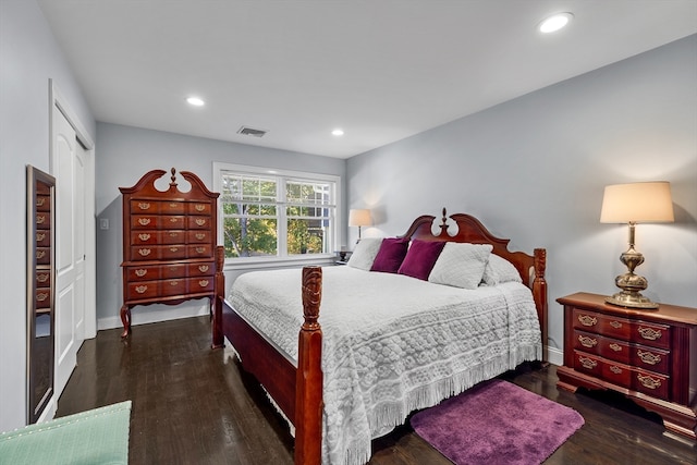 bedroom with dark hardwood / wood-style flooring