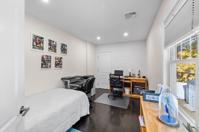 bedroom with dark hardwood / wood-style flooring