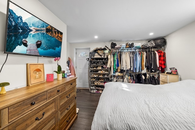 bedroom with dark hardwood / wood-style flooring