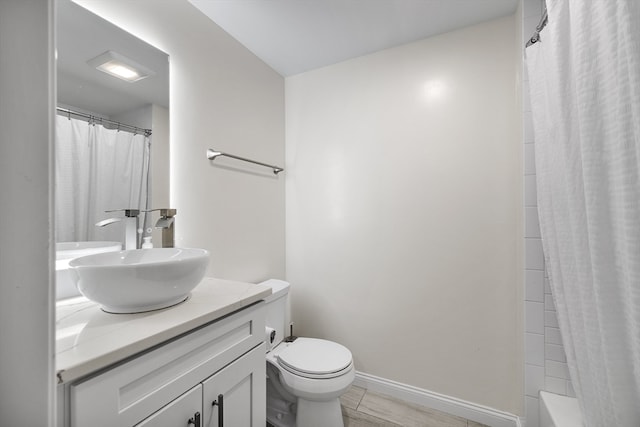 full bathroom with vanity, shower / bath combo, wood-type flooring, and toilet