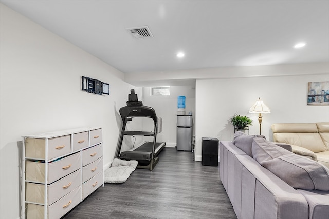 bedroom featuring dark wood-type flooring and stainless steel fridge