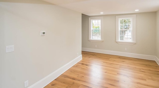 empty room with recessed lighting, baseboards, and light wood finished floors