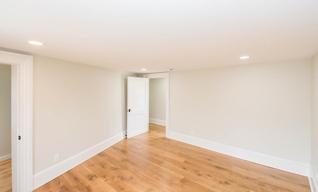 empty room with recessed lighting, baseboards, and light wood-style flooring