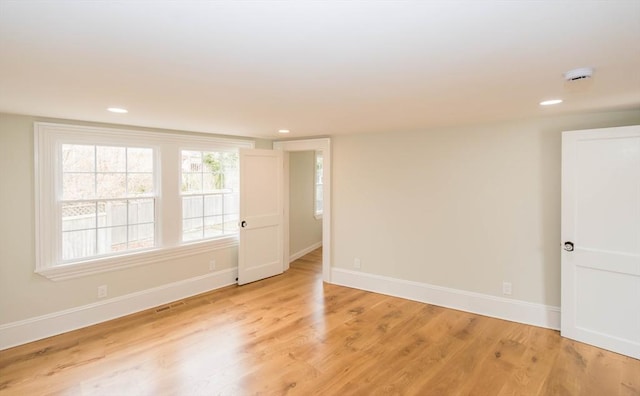 unfurnished room with recessed lighting, baseboards, and light wood-style floors