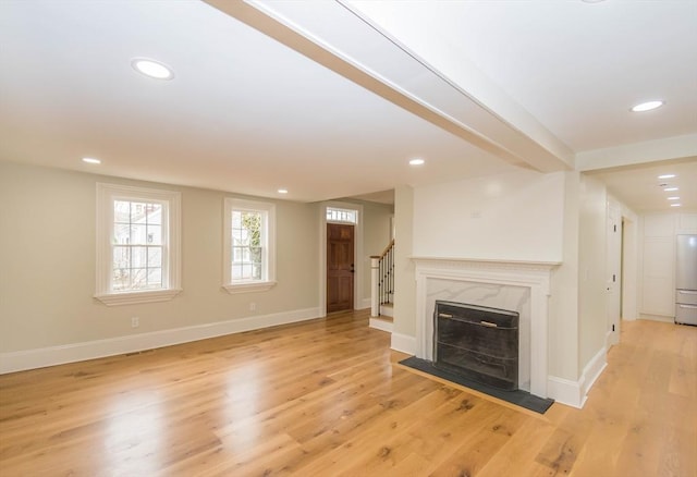 unfurnished living room with recessed lighting, stairway, baseboards, and light wood-style floors