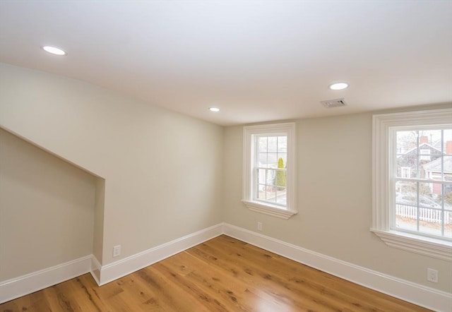 unfurnished room featuring a healthy amount of sunlight and baseboards