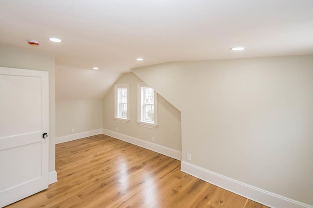 bonus room featuring lofted ceiling, recessed lighting, baseboards, and light wood finished floors